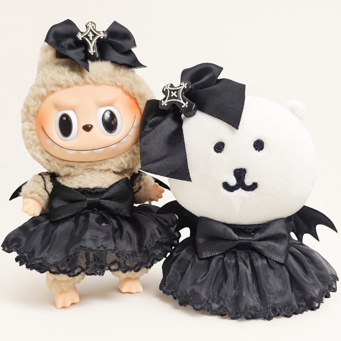 Plush doll wearing the bat wing tutu dress — layered tulle skirt with soft felt bat wings — plush toy clothes sized 15-25 cm