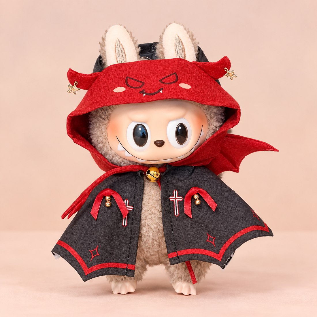 Plush doll wearing hooded little devil cape costume