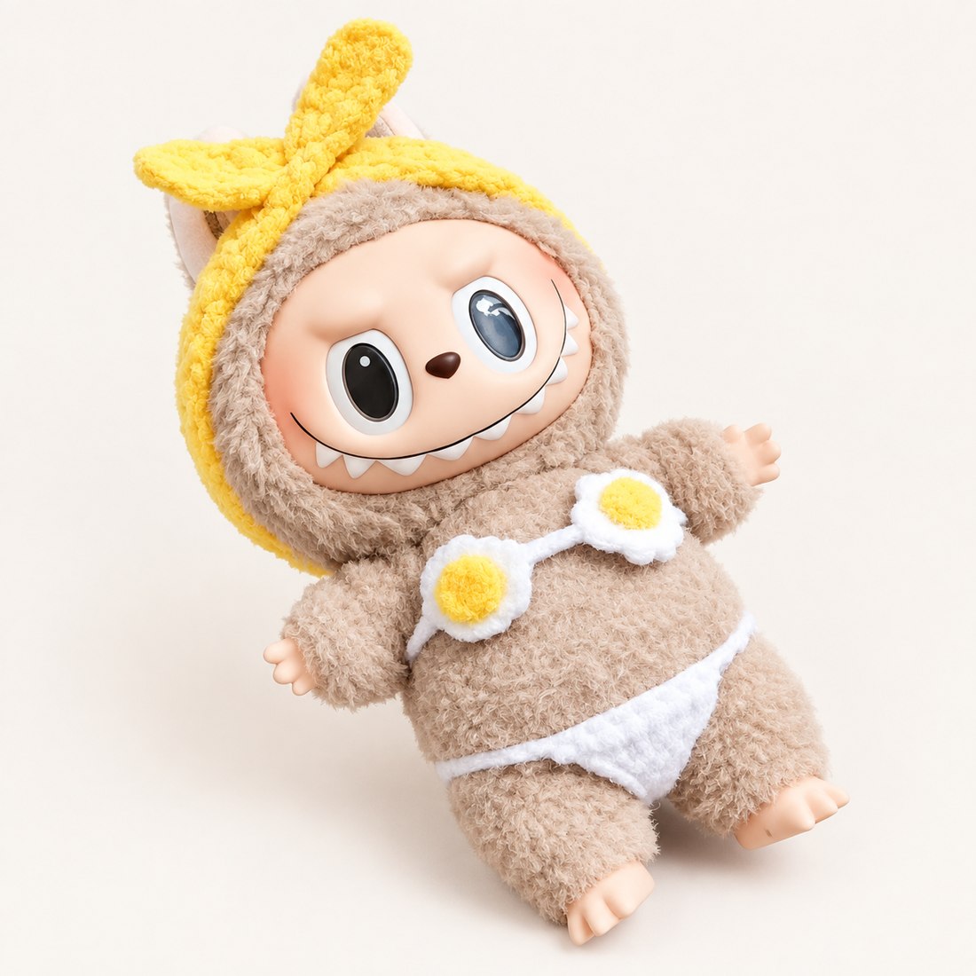 Plush doll wearing fried egg bikini top, bottoms and yellow knit headband — doll clothes for 17 cm Labubu-style plushies