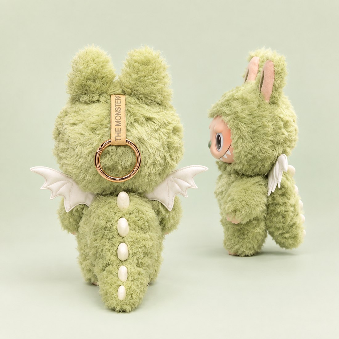 Plush doll wearing green monster costume