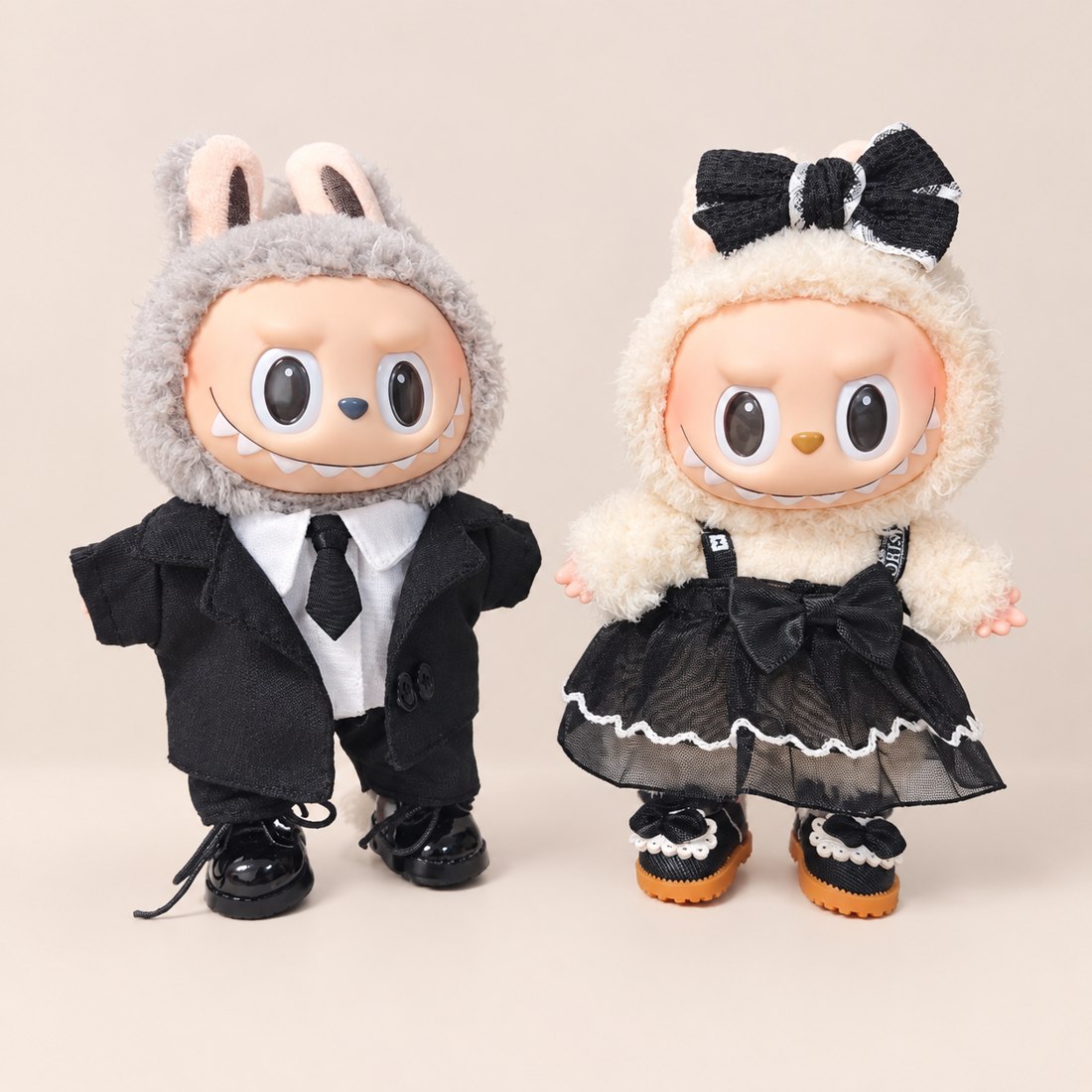Plush doll wearing black suit with white shirt and tie