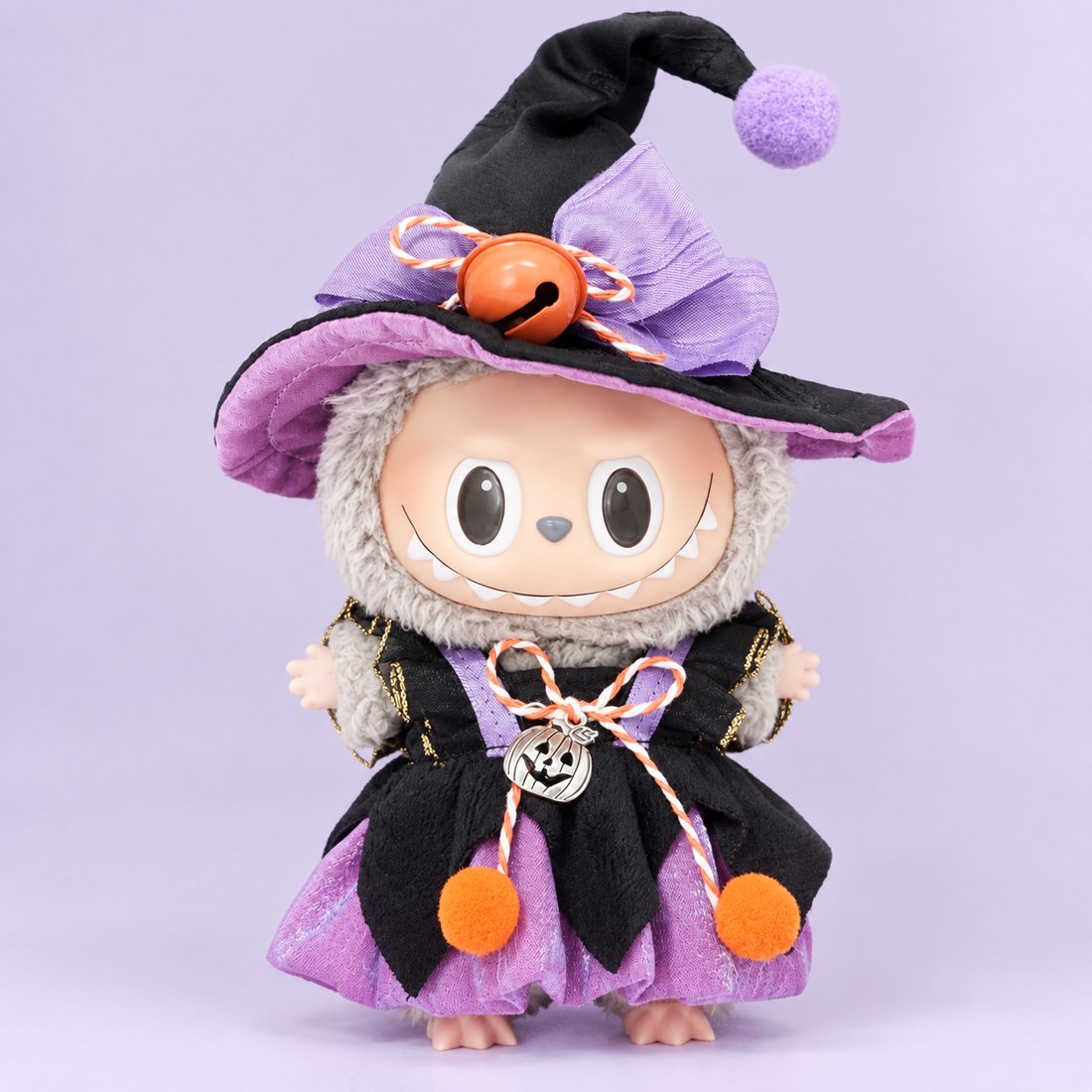 Plush doll wearing witch hat and robe costume