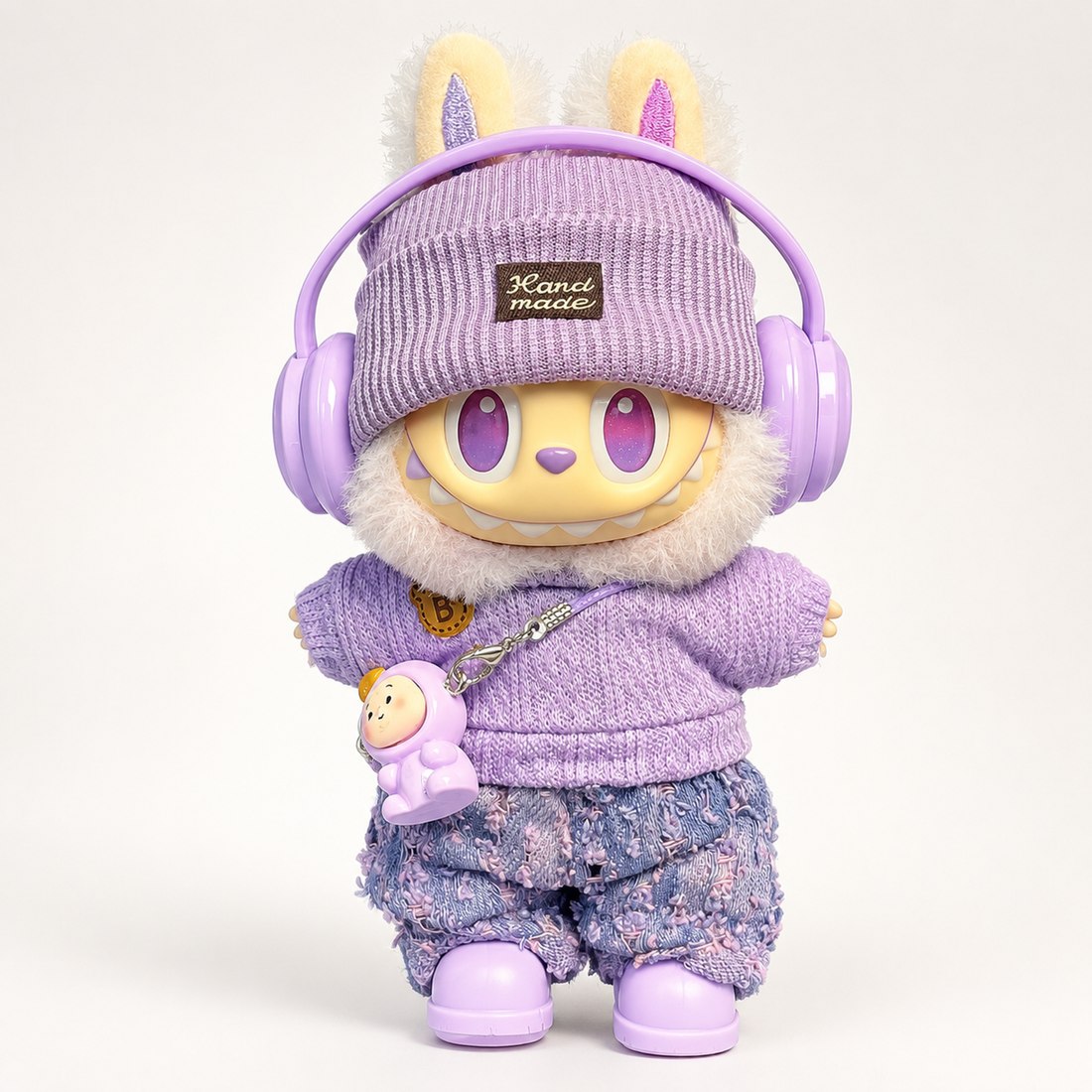 Plush doll wearing the 6-piece lucky purple outfit — hat, sweater, pants, headphones, shoes and charm — doll outfit for Labubu-style and cotton dolls