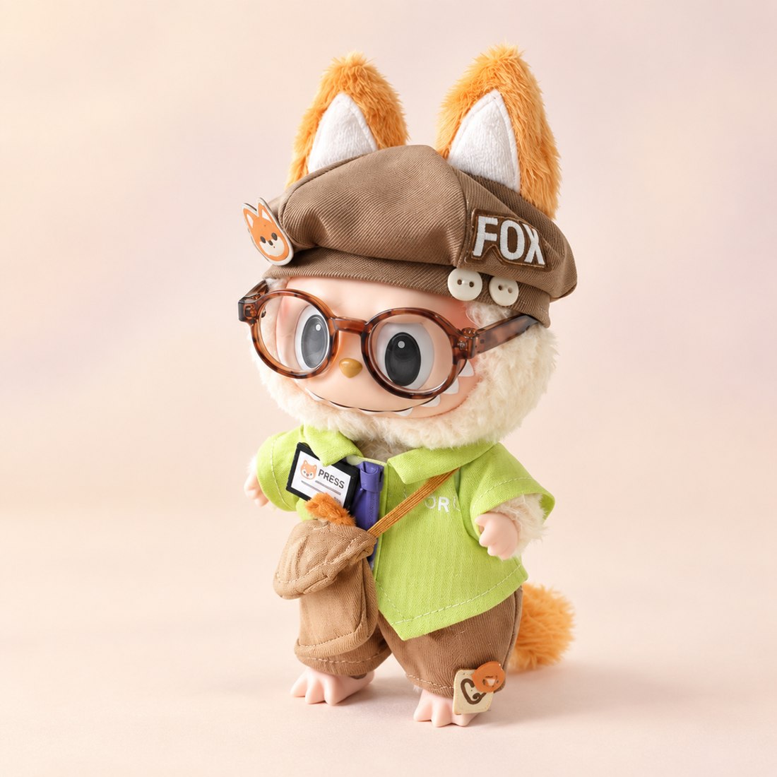 Small 10cm plush doll wearing reporter outfit with press badge