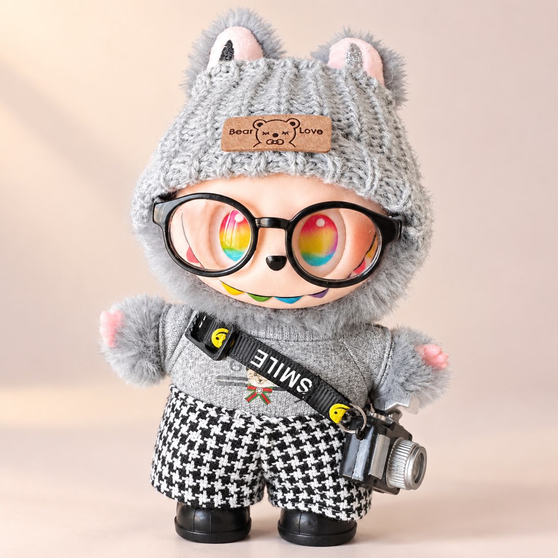 Plush doll wearing photographer outfit with camera