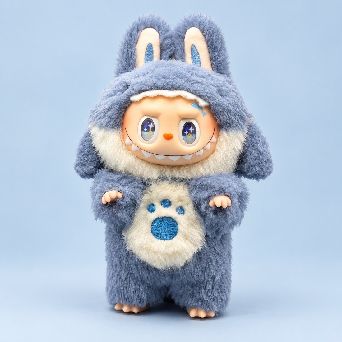 Plush doll wearing blue shark costume with fin