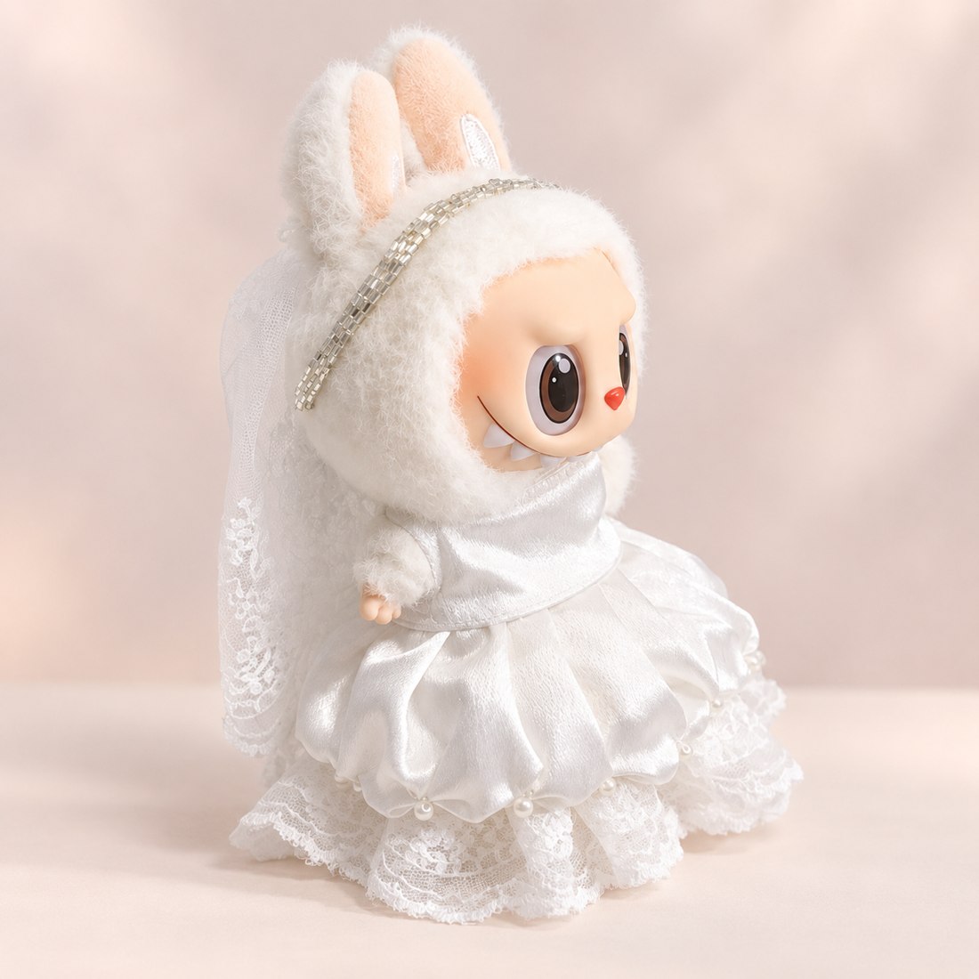 Plush doll wearing satin wedding gown with veil and headband