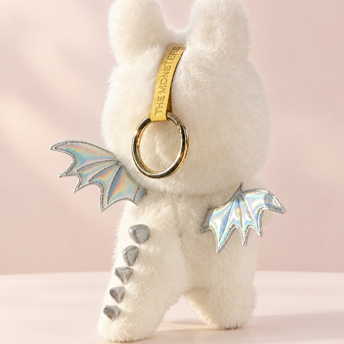 Plush doll wearing soft white dinosaur costume